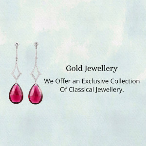 Pair of ruby and diamond earrings on a light blue background