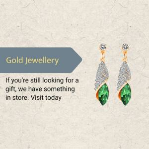 Close-up of gold earrings with green emerald stones