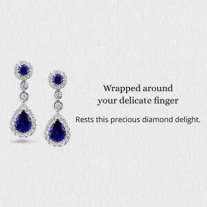 Close-up of elegant sapphire and diamond drop earrings on a white background.