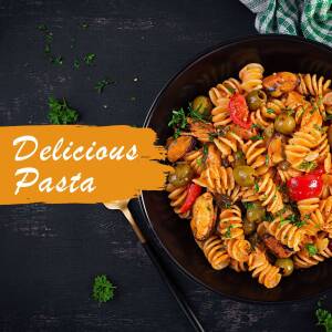 Close-up of a pasta dish with vegetables in a black bowl