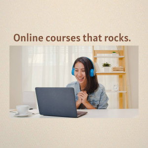 Woman wearing headphones and smiling while using a laptop for an online course.