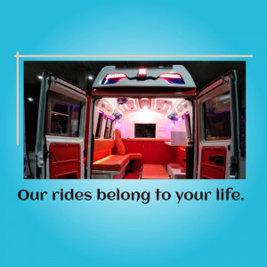 Interior view of a modern, well-equipped ambulance with red seating and lighting.