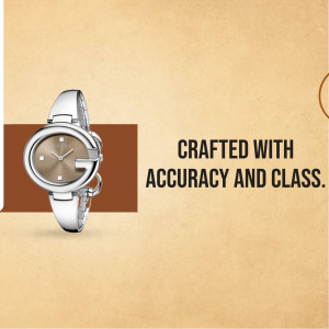 Silver Gucci watch with brown face and strap on a beige background