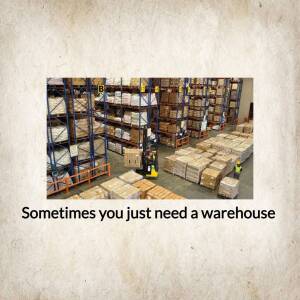 Interior view of a large warehouse with stacked boxes and a forklift.