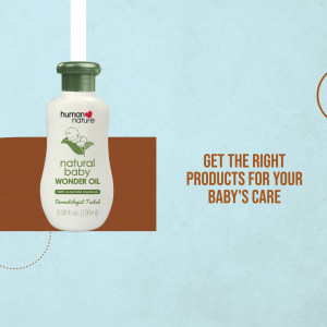Human Nature Natural Baby Wonder Oil bottle on a light blue and brown background with text.