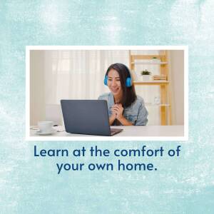 Woman smiling while using a laptop for online learning.