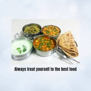 A stainless steel Indian thali with various curries, rice, and roti.