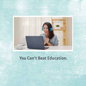 Woman smiling while using a laptop for online learning