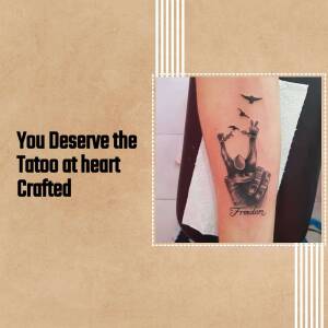 Black and grey tattoo of a bird breaking free from shackles on a forearm.