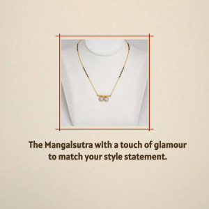 Close-up of a gold mangalsutra necklace with pearl pendants on a white mannequin.