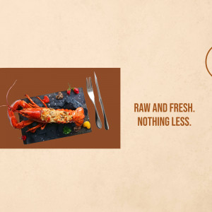 A beautifully presented cooked lobster on a slate plate with silverware and garnish.