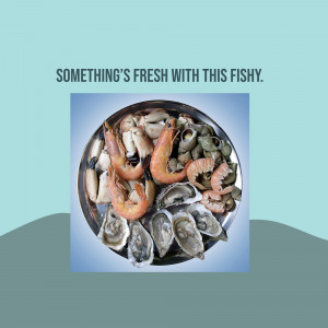 A close-up of a platter filled with various types of fresh seafood, including shrimp, oysters, and mussels.