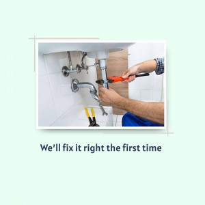 A plumber using a wrench to fix a sink drain.