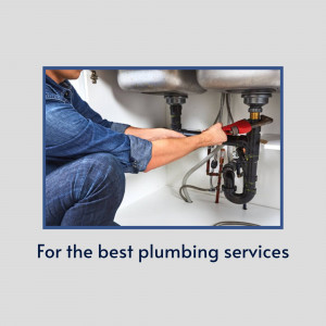 Plumber repairing pipes under a sink