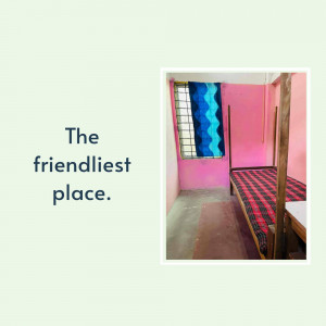A simple room with a bed and pink walls.