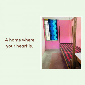 A simple bedroom with a pink wall and a bed.