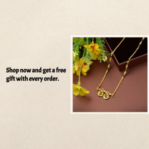 Close-up of a gold mangalsutra necklace displayed with yellow flowers and a gift box.