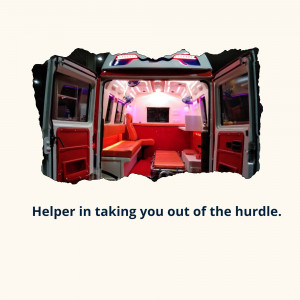 Interior view of an ambulance with red and white seating and medical equipment.