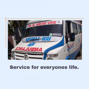 Blue and white ambulance with 'M.K. Ambulance Service' written on it