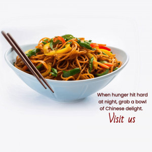 A bowl of Chinese noodles with vegetables and chopsticks.
