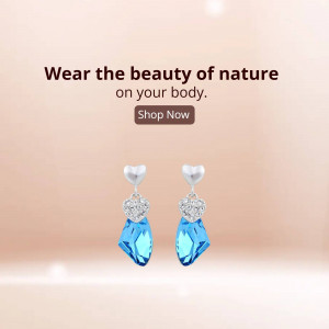 Close-up of blue heart-shaped crystal earrings with a promotional banner.