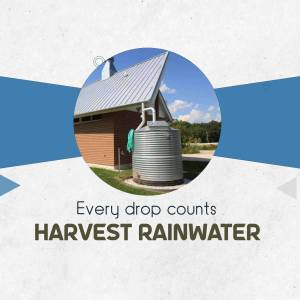 Image of a rainwater harvesting system with a water tank and a modern building in the background.