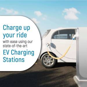 White electric car charging at a station