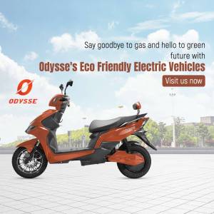 Orange Odysse electric scooter parked on a street with a blurred background.