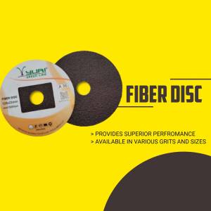 Close-up of a Yuri brand fiber disc against a yellow background.