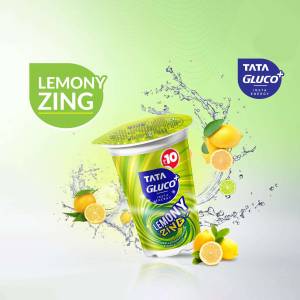 A promotional image of Tata Gluco Lemony Zing drink in a white cup with lemons and a splash effect.
