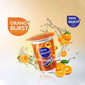 A promotional image of Tata Gluco+ Orangy Burst yogurt with oranges and splash effects.