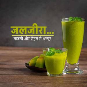 Two glasses of Jaljeera with lime and mint, served on a wooden surface.