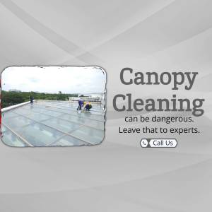 Workers cleaning a glass canopy roof with safety equipment.