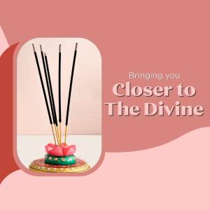A close-up of black incense sticks in a colorful lotus flower holder.