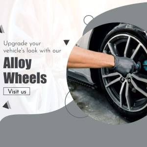 Close-up of a mechanic installing alloy wheels on a car