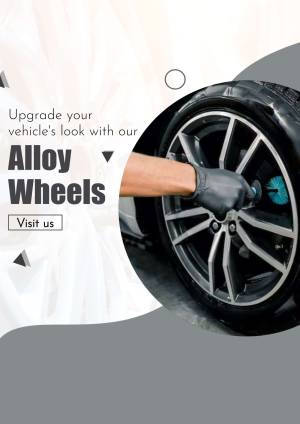 Close-up of a mechanic installing an alloy wheel on a car
