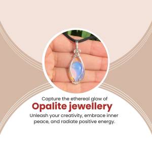 Close-up of a silver pendant with an opalite gemstone held in a hand.
