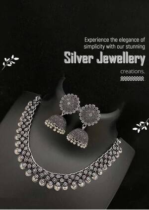 Close-up of a silver necklace and earrings set on a dark background