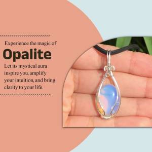 Close-up of a silver wire-wrapped opalite pendant necklace held in a hand.