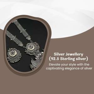 Close-up of a silver jewellery set with intricate designs on a dark background.