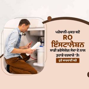 Man installing or repairing a RO water purifier under the kitchen sink.