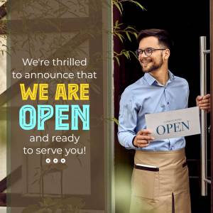 A smiling man holding an 'Open' sign in front of a business entrance.
