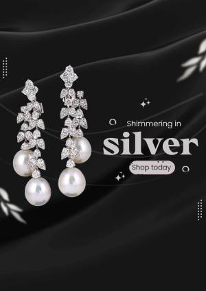 Close-up of elegant silver earrings with pearls and diamonds