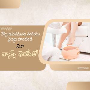 A person receiving a foot spa treatment with a warm foot bath.