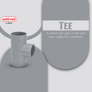 Close-up of an Ashirvad Tee pipe fitting, a grey plastic connector for agricultural irrigation.