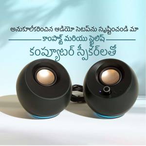 Pair of black computer speakers with blue accents on a white surface
