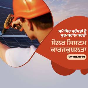 A worker installing a solar panel with a screwdriver.