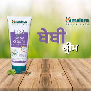 Himalaya Baby Cream tube on a wooden surface
