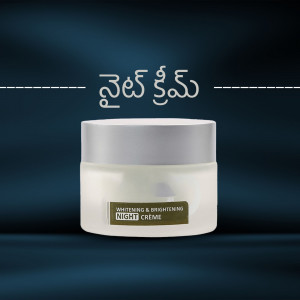 Close-up of a white night cream jar with a silver lid on a dark blue background.