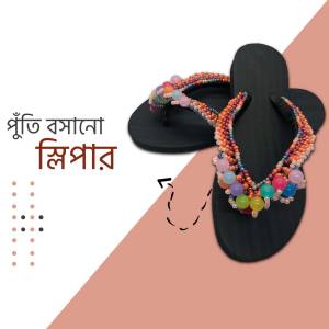 Close-up of black flip-flops adorned with colorful beaded straps
